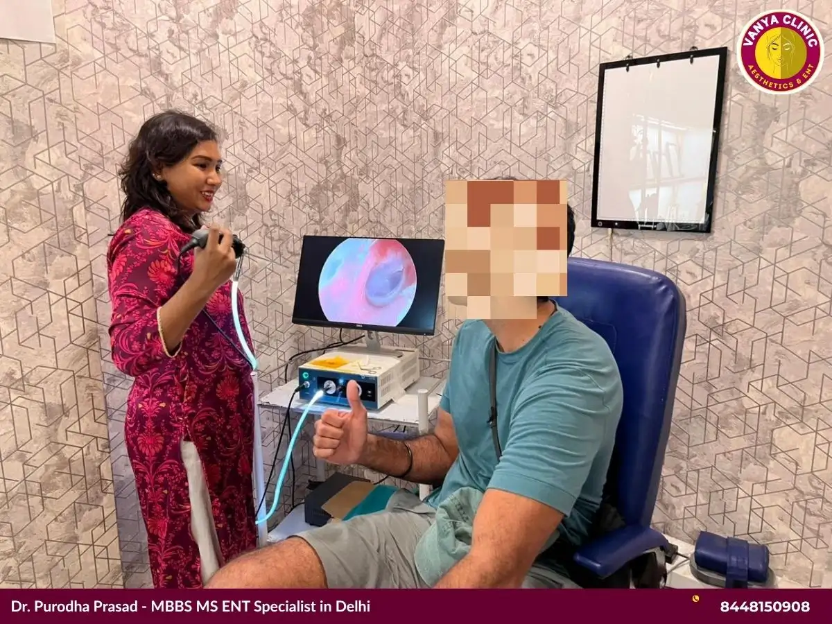 Dr. Purodha Prasad showing patient a clean ear canal on endoscope in Delhi.
