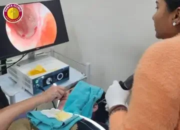 Dr Purodha Prasad doing deep ear cleaning.