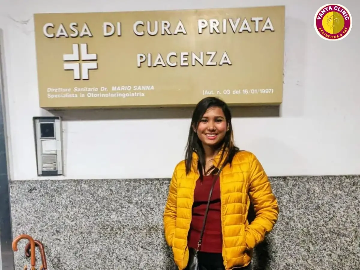 Dr. Purodha Prasad standing in front of Casa Di Cura Privata Piacenza, Italy signage.