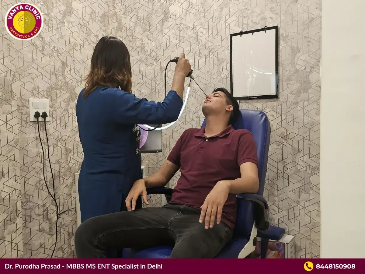 Dr. Purodha Prasad removing foreign body from nose of male patient in Delhi.
