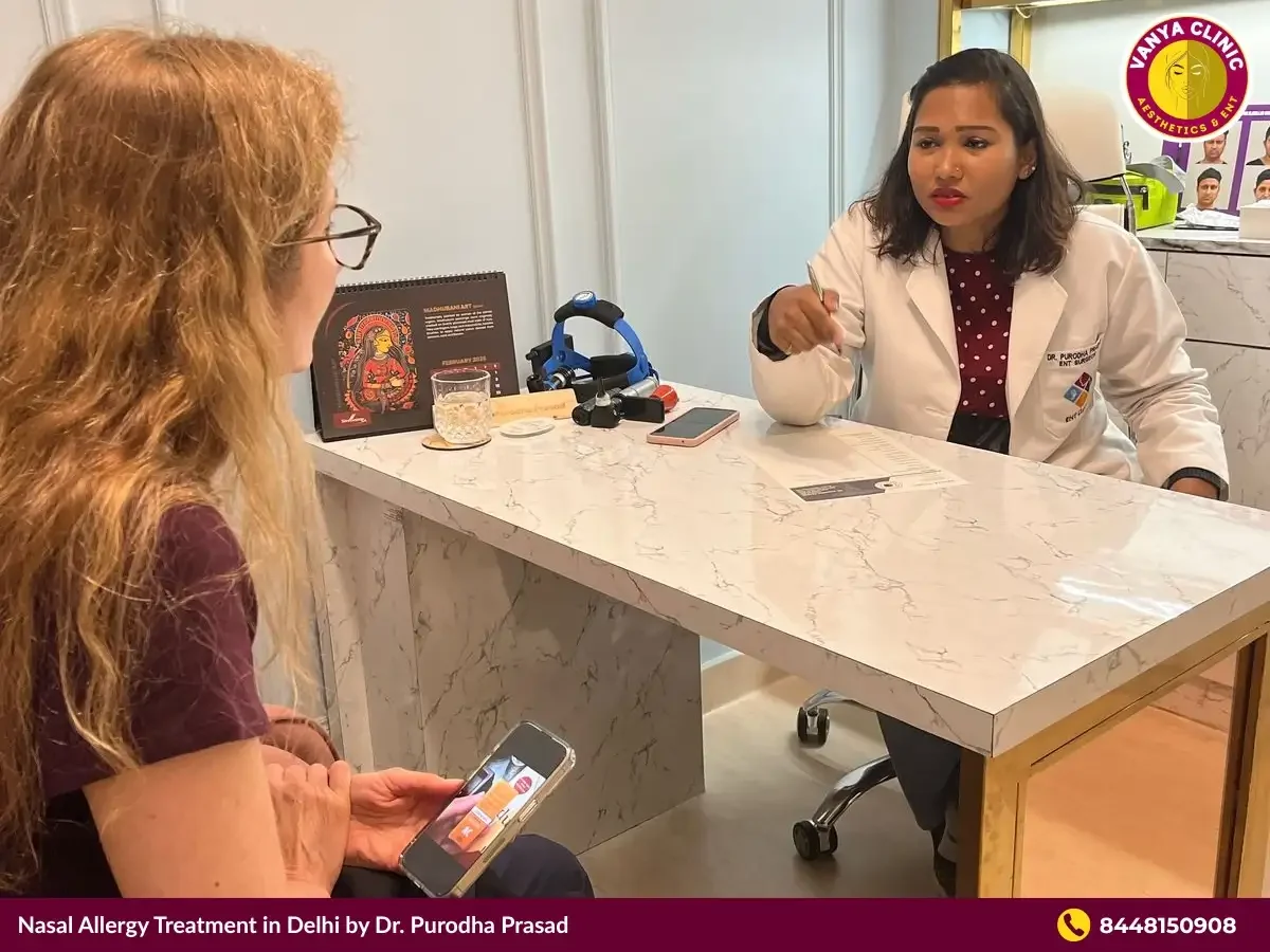 Dr. Purodha Prasad consulting with patient for nasal allergy.