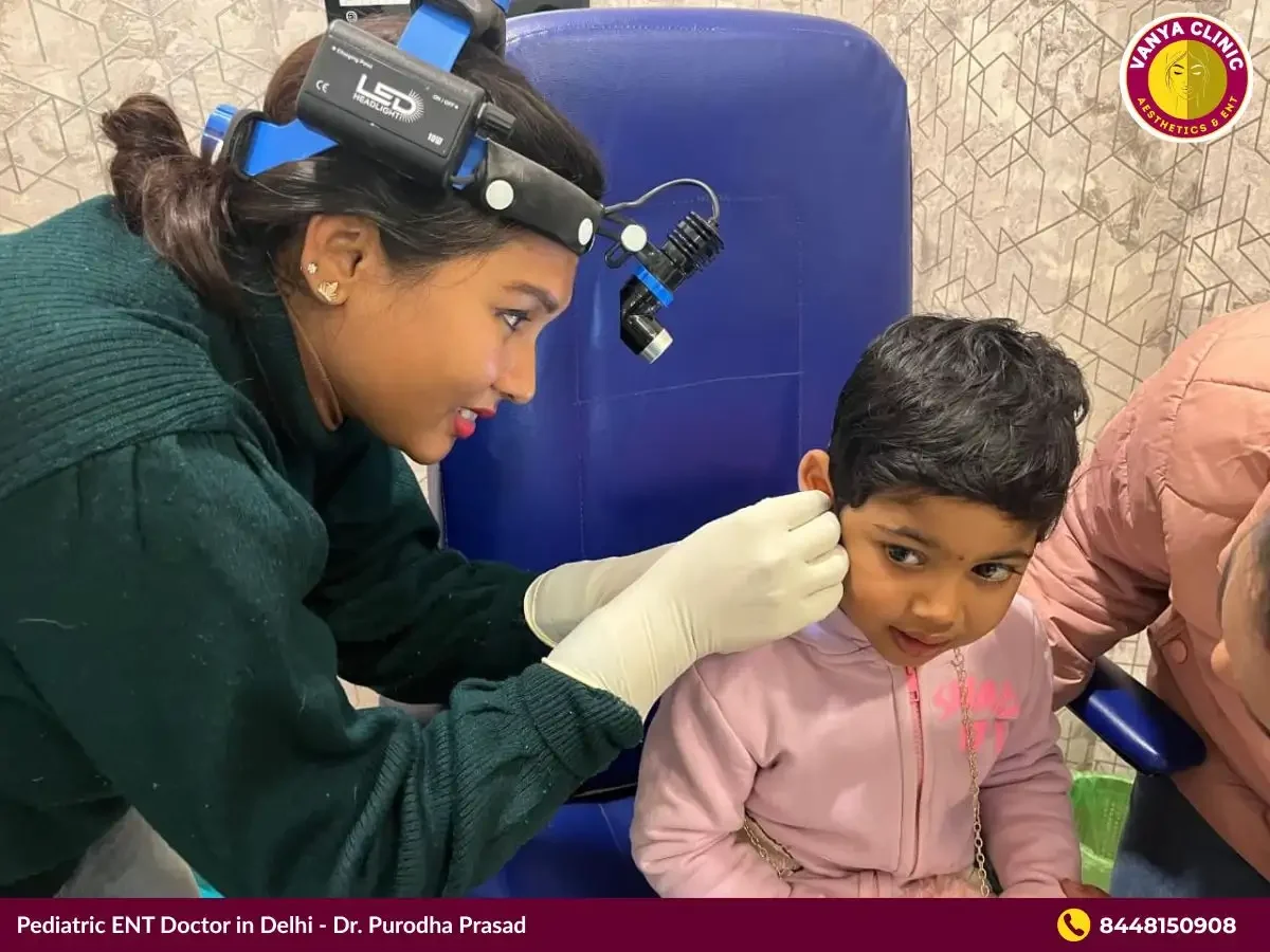 Dr. Purodha Prasad performing Ear treatment for girl child in Delhi.