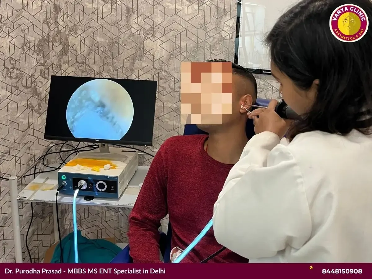 Dr. Purodha Prasad performing ear cleaning in Delhi.