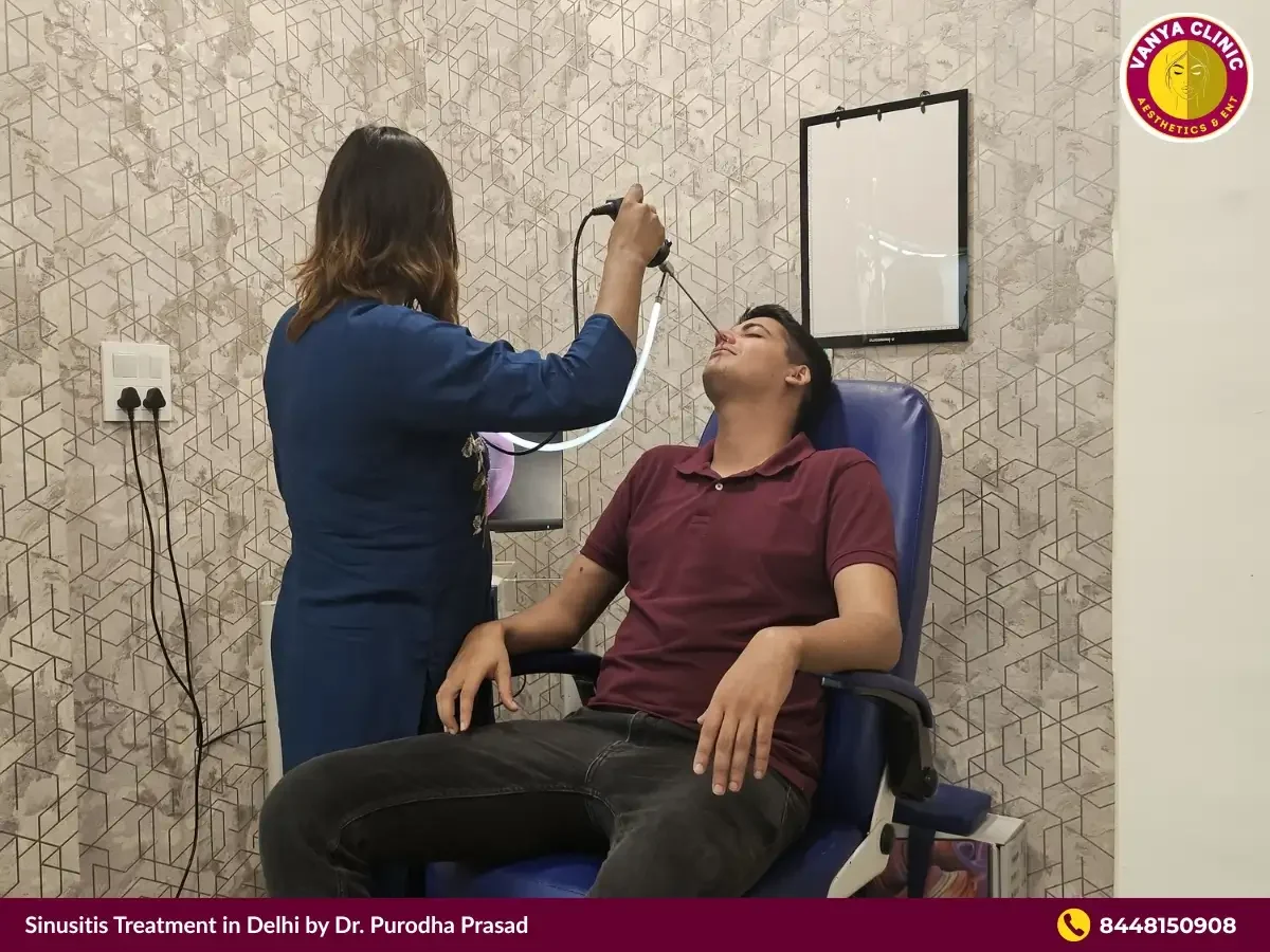 Dr. Purodha Prasad inspecting nose for sinus infection in Delhi.