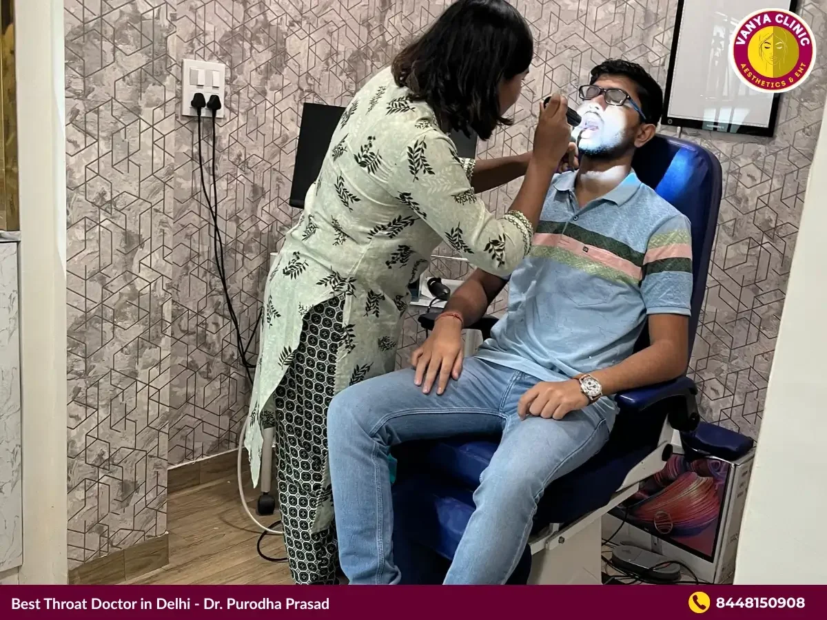 Dr. Purodha Prasad doing throat infection checkup.