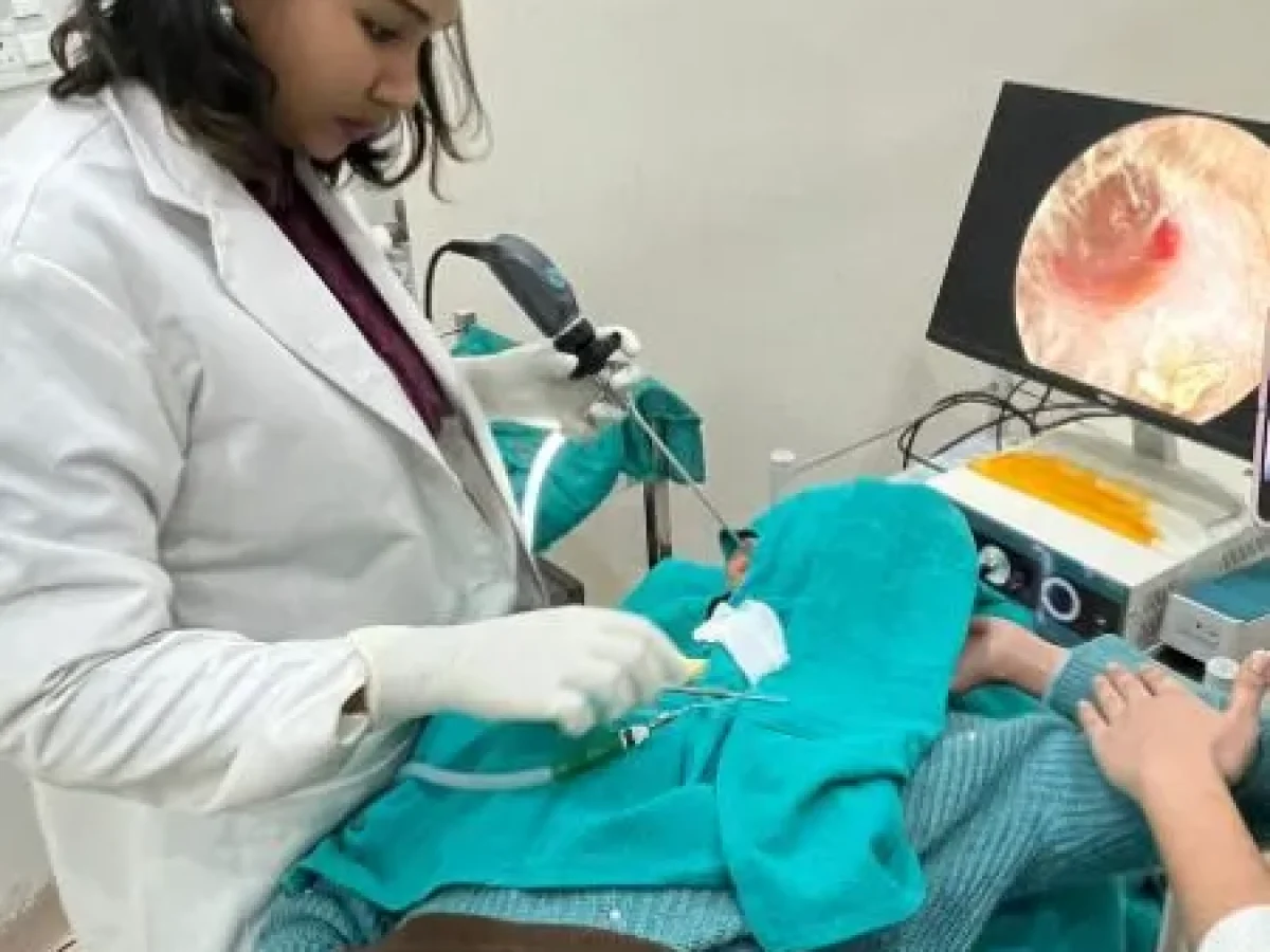 Dr. Purodha Prasad holding endoscope in patient ear in Delhi.