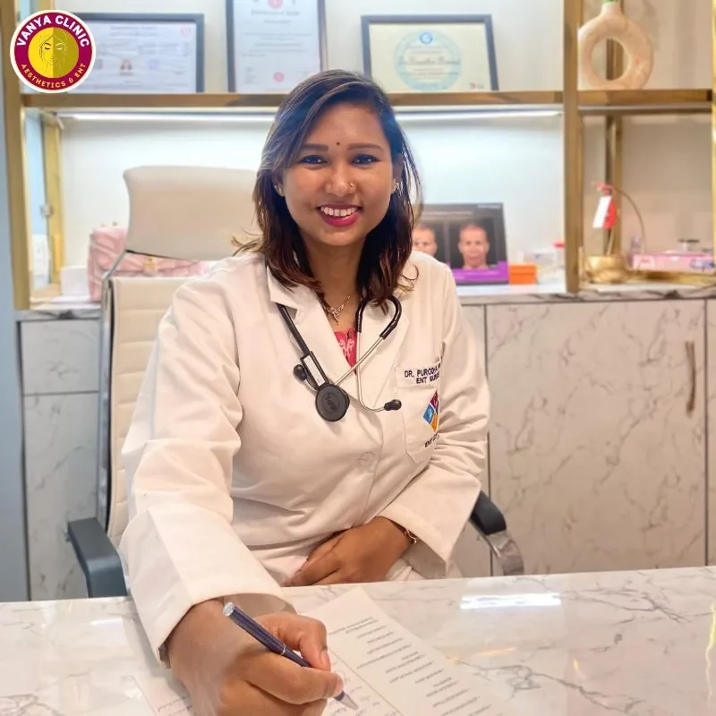 Dr. Purodha Prasad with a pen in hand sitting on chair.